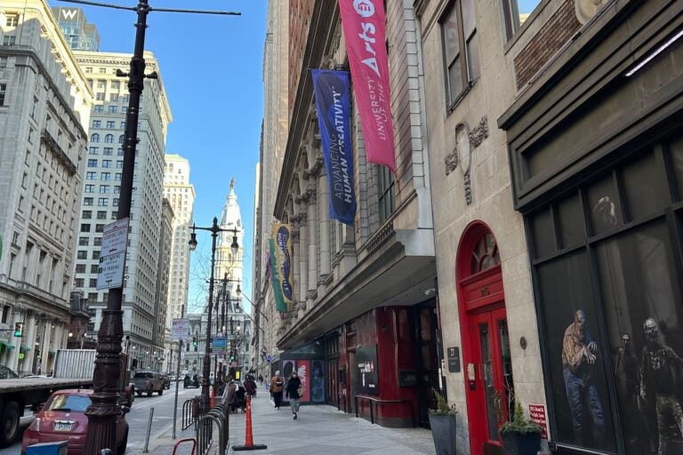 UArts building on a busy stretch of Broad Street, with City Hall visible in the background