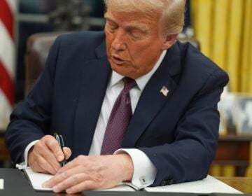 Donald Trump signing an executive order at his desk