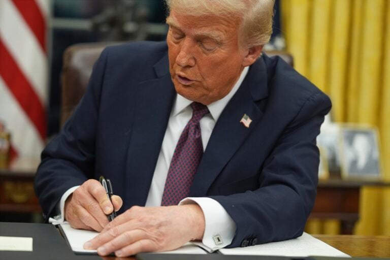 Donald Trump signing an executive order at his desk