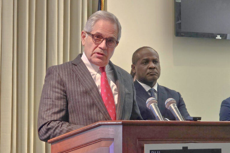 Larry Krasner speaking at a podium