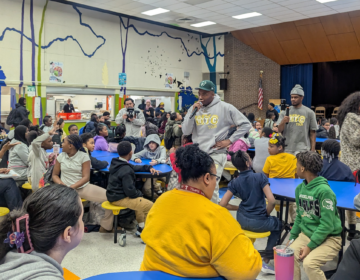 DJ Deezy addressing a room full of school children