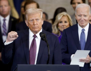 President Donald Trump wraps up his speech during the 60th Presidential Inauguration in the Rotunda of the U.S. Capitol in Washington, Monday, Jan. 20, 2025, as former President Joe Biden looks on.