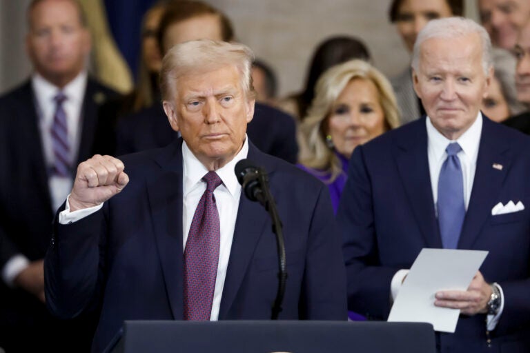 President Donald Trump wraps up his speech during the 60th Presidential Inauguration in the Rotunda of the U.S. Capitol in Washington, Monday, Jan. 20, 2025, as former President Joe Biden looks on.