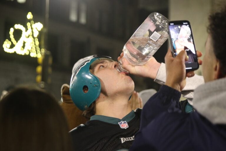 a fan chugs a bottle of liquid