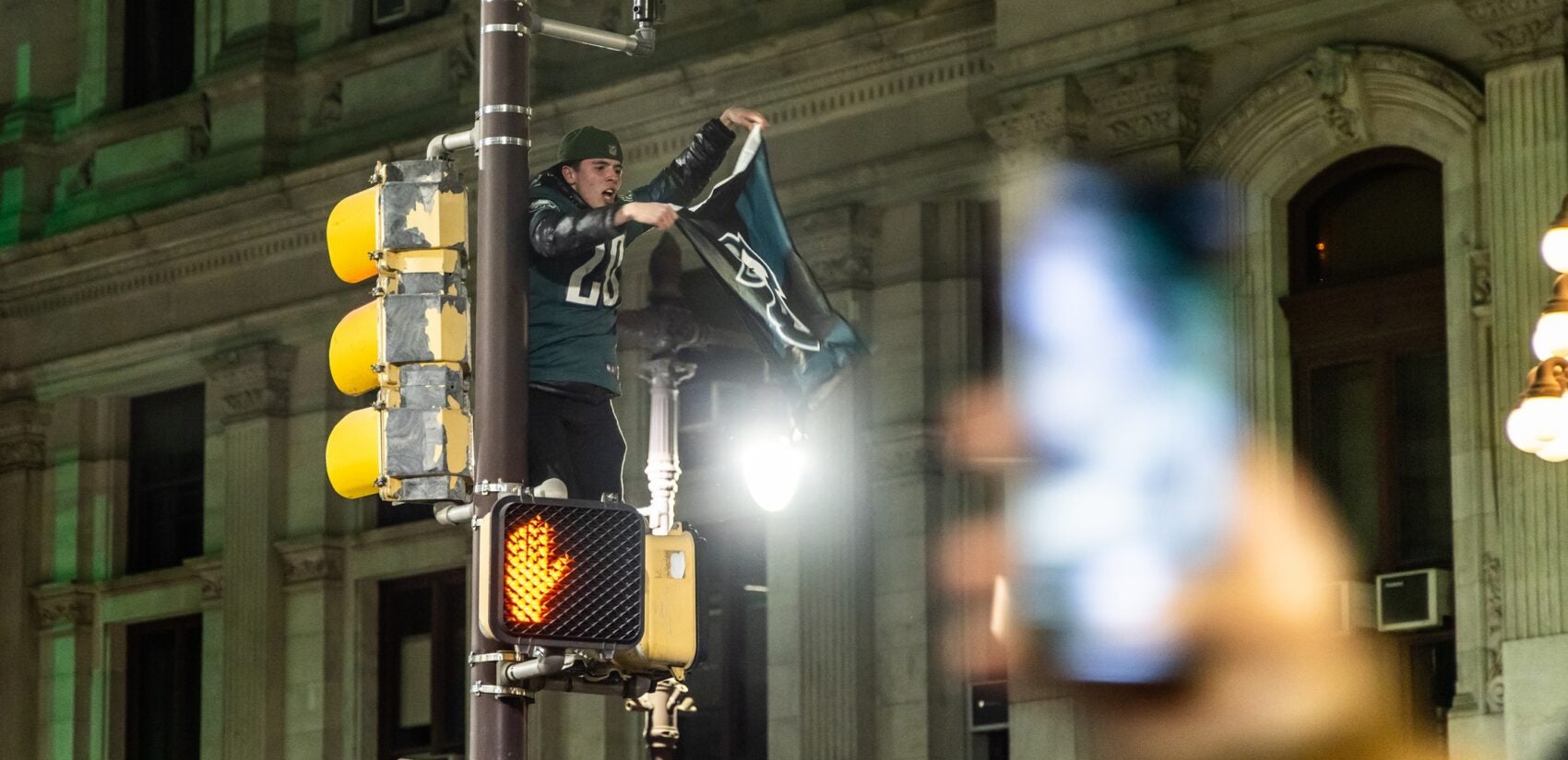 a fan on a street light with an Eagles flag