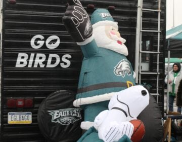 an inflatable Santa in Eagles gear, and an inflatable Snoopy with a football