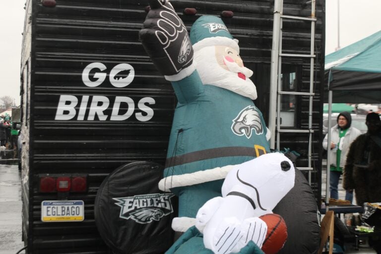 an inflatable Santa in Eagles gear, and an inflatable Snoopy with a football