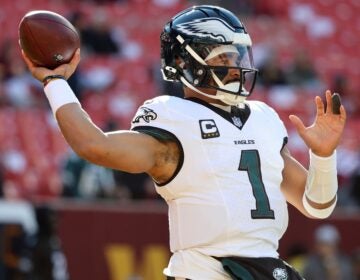 Jalen Hurts throws a ball