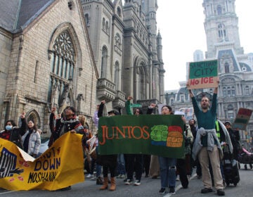 Dozens rallied at City Hall on Dec. 10, 2024, calling on Philadelphia elected officials to reaffirm sanctuary city protections for undocumented residents. (Emily Neil/WHYY)