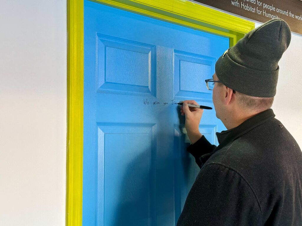 Governor-elect Matt Meyer signs a door frame