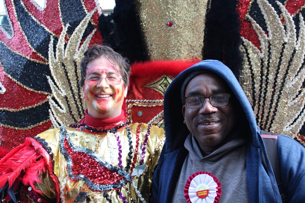 Mike Carwile, left, a member of the Golden Sunrise Mummer club