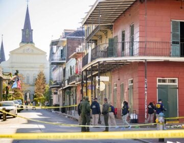 Members of the FBI work on Orleans Street and Bourbon Street