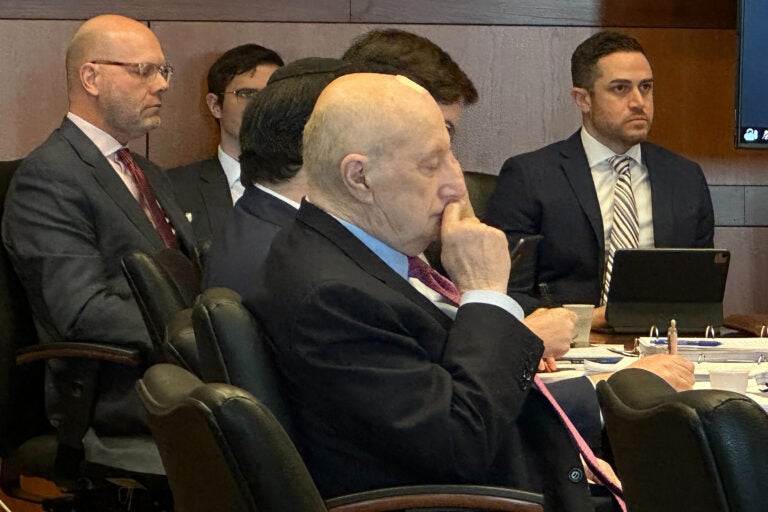 A team of lawyers sitting int he courtroom