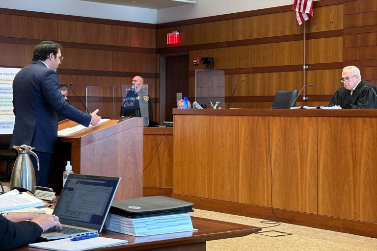 A lawyer addresses a judge from a podium