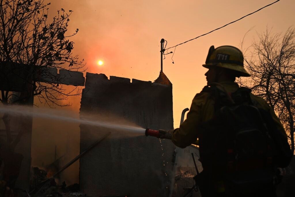 Firefighter waters down a home