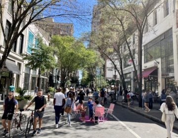 Lots of people walking around on a closed busy street