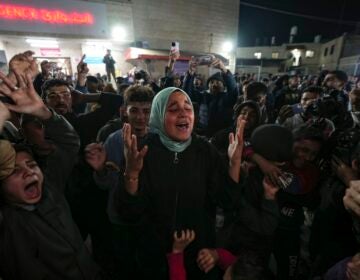 Palestinians celebrate the announcement of a ceasefire deal