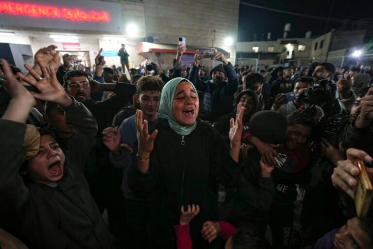 Palestinians celebrate the announcement of a ceasefire deal