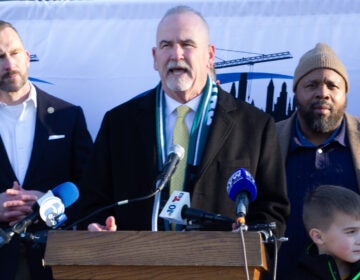 Pat Dugan speaks behind a podium