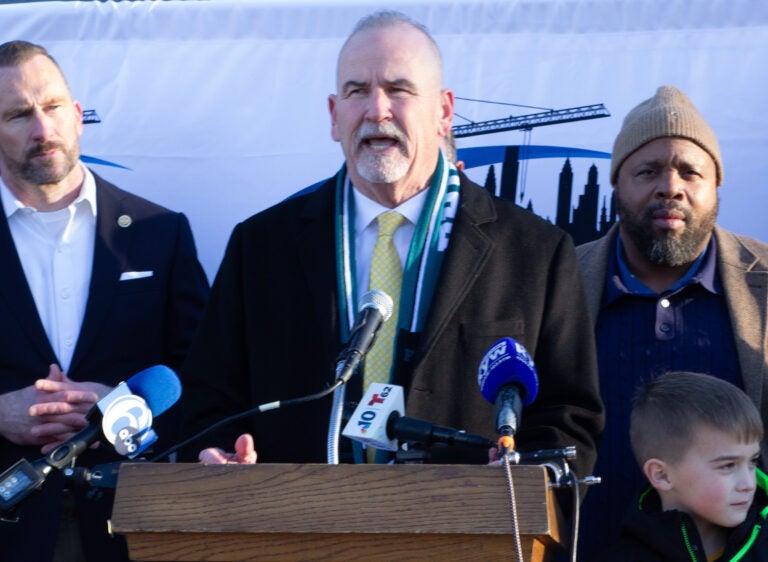 Pat Dugan speaks behind a podium