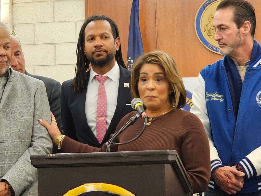 Quetcy Lozada speaks behind a podium