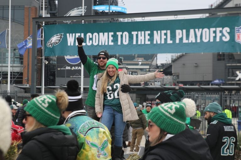 Two Eagles fans on a stage surrounded by others