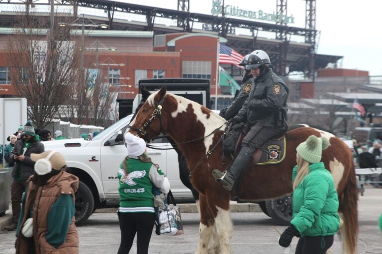 two policemen on a horse with Eagles fans