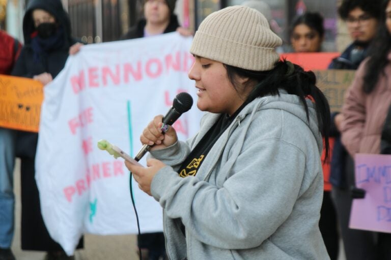 Lenore Ramos Juarez speaks into a microphone