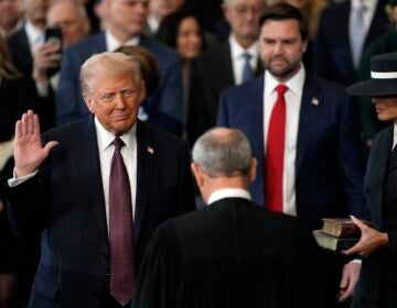 Donald Trump is sworn in as the 47th president of the United States by Chief Justice John Roberts as Melania Trump holds the Bible during the 60th Presidential Inauguration in the Rotunda of the U.S. Capitol in Washington, Monday, Jan. 20, 2025.