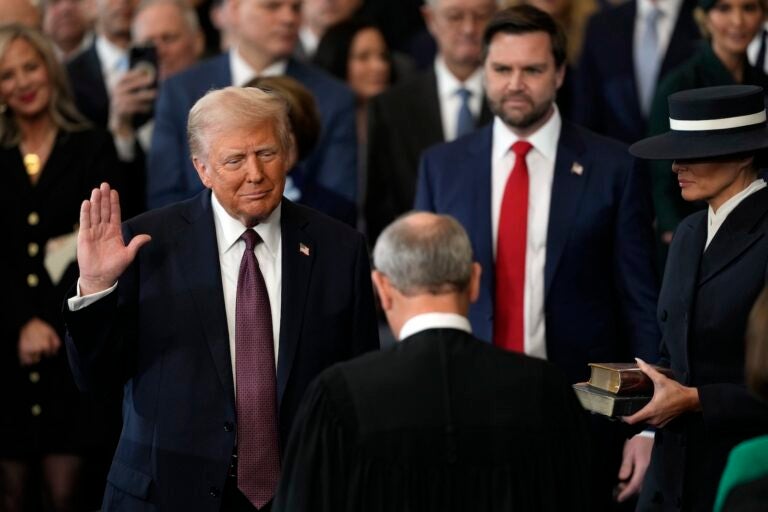 Donald Trump is sworn in as the 47th president of the United States by Chief Justice John Roberts as Melania Trump holds the Bible during the 60th Presidential Inauguration in the Rotunda of the U.S. Capitol in Washington, Monday, Jan. 20, 2025.