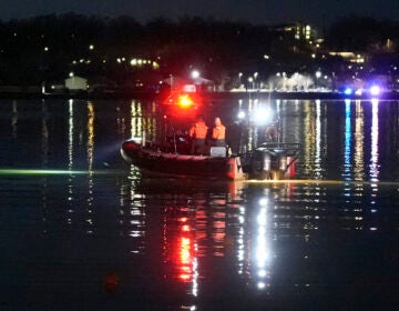 A boat works the scene near Ronald Reagan Washington National Airport, Thursday, Jan. 30, 2025, in Arlington, Va.