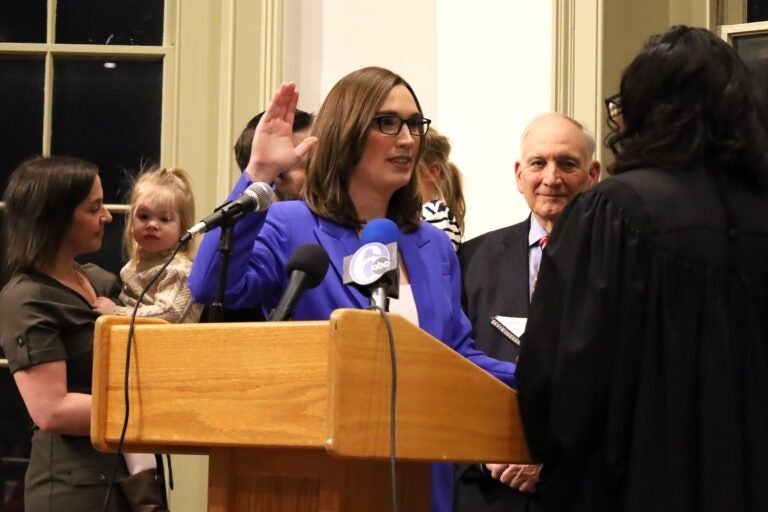 Sarah McBride holds up her hand for the oath