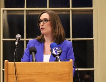 Sarah McBride speaks behind a podium