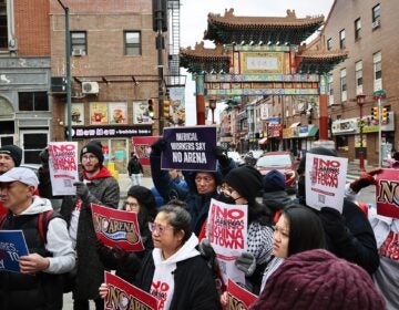 Arena opponents gather and hold signs reading NO ARENA IN CHINATOWN and MEDICAL WORKERS SAY NO ARENA