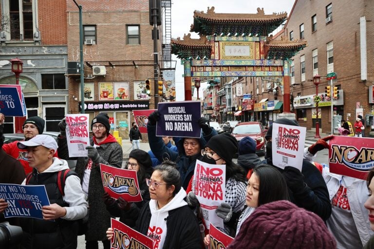 Arena opponents gather and hold signs reading NO ARENA IN CHINATOWN and MEDICAL WORKERS SAY NO ARENA