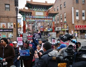 Arena opponents gather and hold signs reading NO ARENA IN CHINATOWN and MEDICAL WORKERS SAY NO ARENA