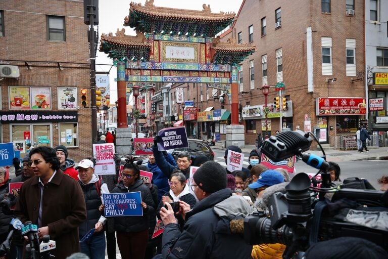 Arena opponents gather and hold signs reading NO ARENA IN CHINATOWN and MEDICAL WORKERS SAY NO ARENA