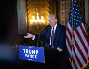 Donald Trump speaking at a podium