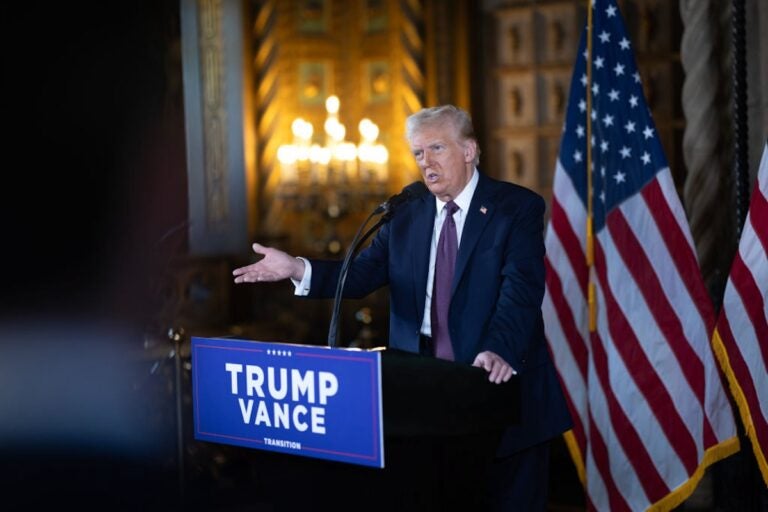 Donald Trump speaking at a podium