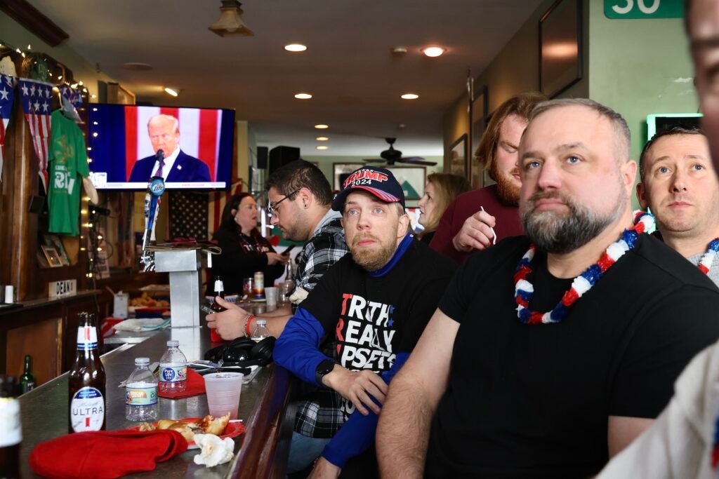 Trump supporters watching his speech in the bar