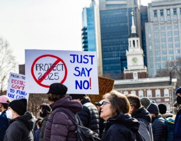 protesters walking. one sign reads JUST SAY NO and has the words PROJECT 2025 covered in a no symbol