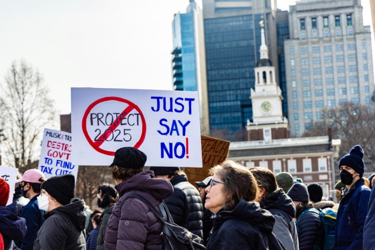 protesters walking. one sign reads JUST SAY NO and has the words PROJECT 2025 covered in a no symbol