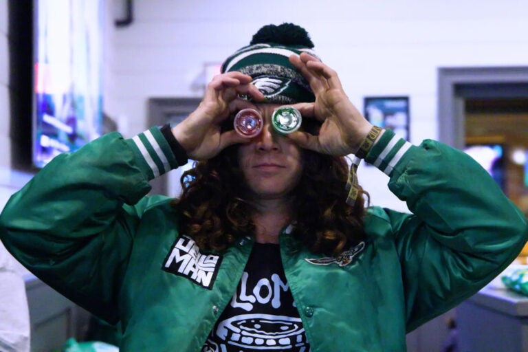 Paul Vile, aka Jelloman, holds up Jell-O shots in front of his eyes