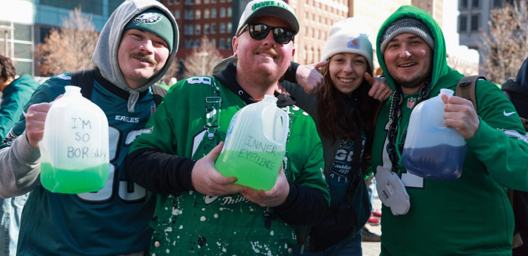 Eagles fans holding jugs of a green drink