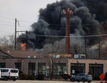 Black smoke rising in the sky from the fire