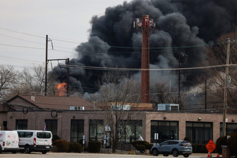 Black smoke rising in the sky from the fire