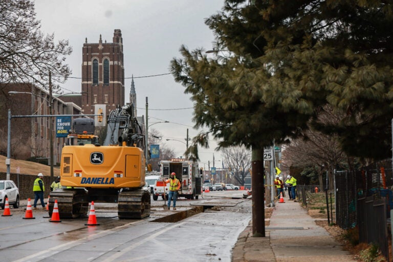 Workers dig up the street to fix the gas leak.