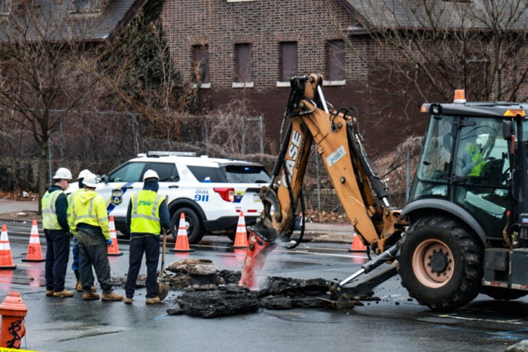 Workers dig up the street to fix the gas leak.