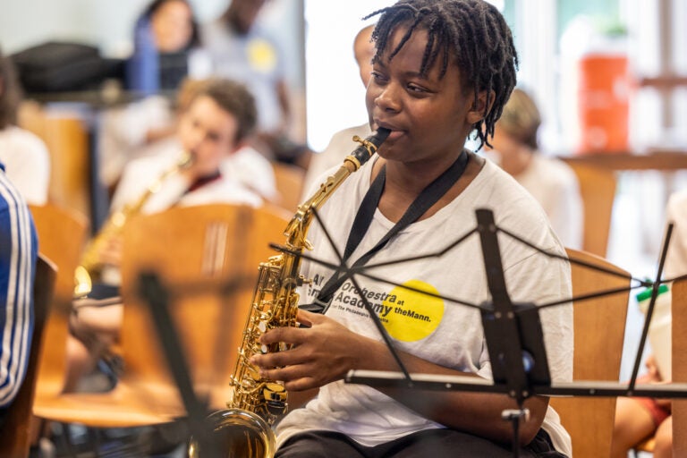 A teenager playing the saxophone