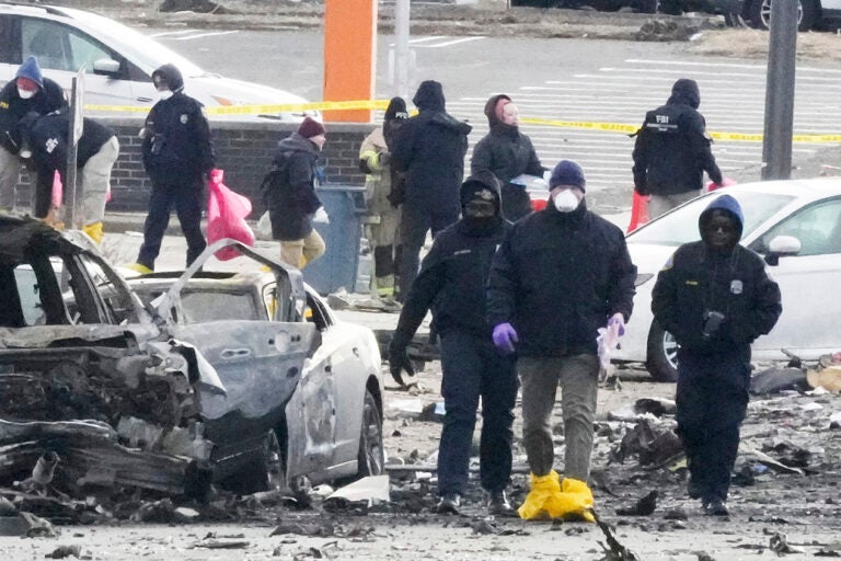 Investigators work the scene after a small plane crashed in Philadelphia, Saturday, Feb. 1, 2025. (AP Photo/Matt Rourke)